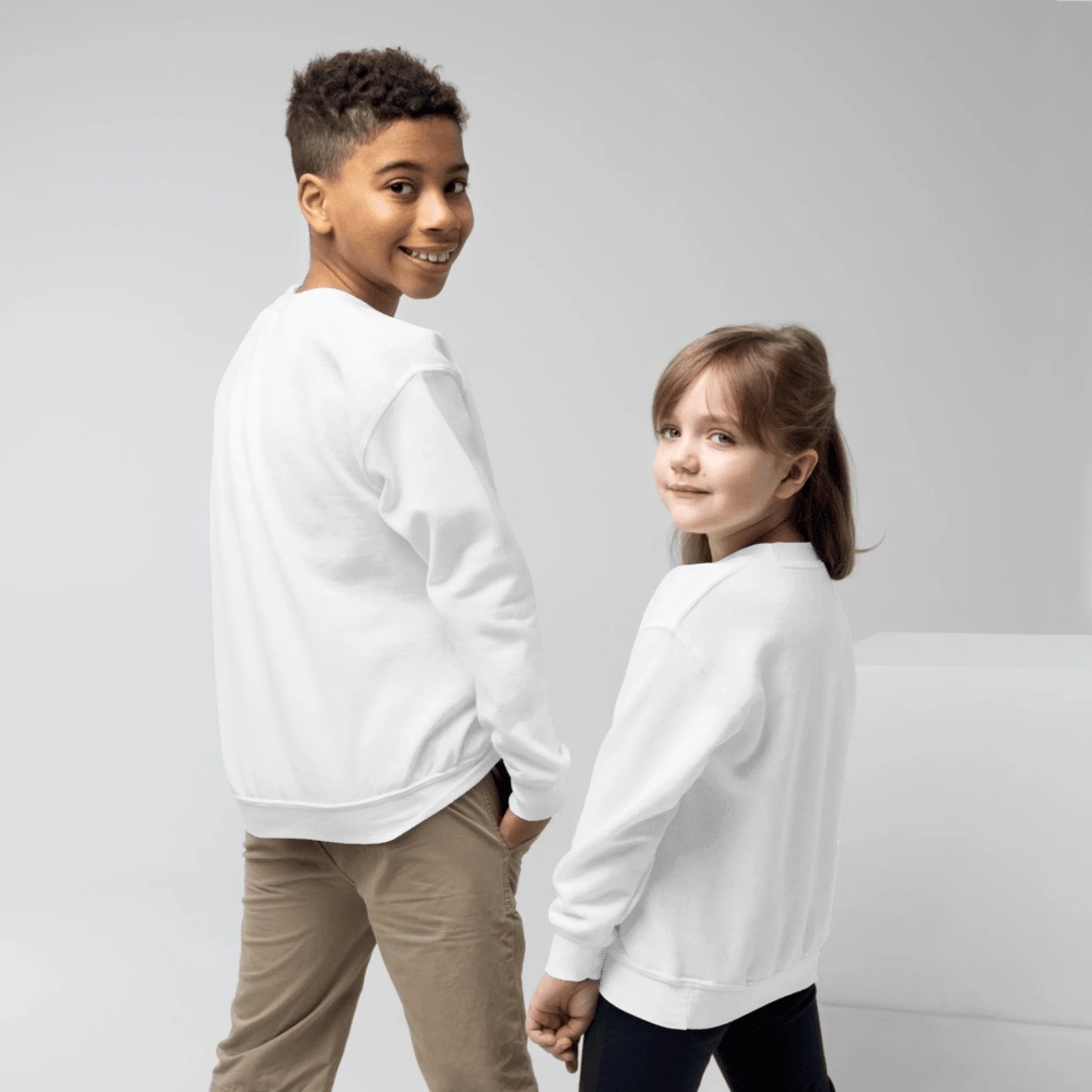 Lifestyle styling of personalized youth crewneck sweatshirt — kids apparel ready for cooler days